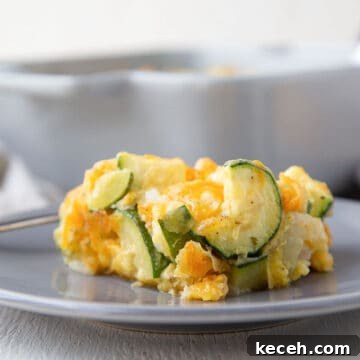 slice of old fashioned zucchini casserole on a gray plate.