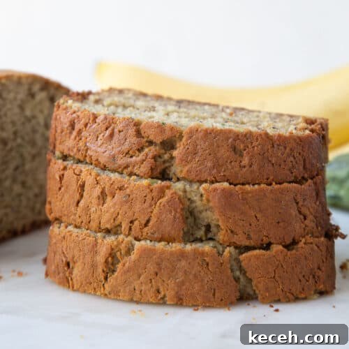three slices of banana zucchini bread stacked on top of each other.