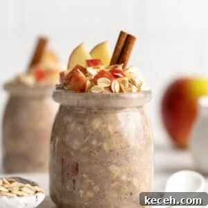 Apple Pie Overnight Oats Recipe for Cozy Fall M mornings 5 two jars apple overnight oats with cinnamon sticks, oats and apples topping them