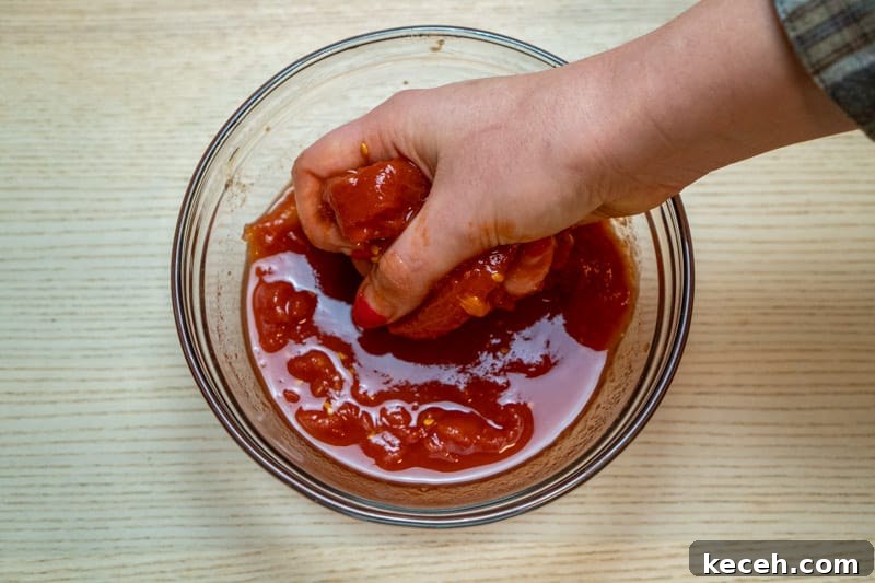 Vegan Puttanesca Sauce Recipe Without Anchovies 7 Crushing the whole tomatoes