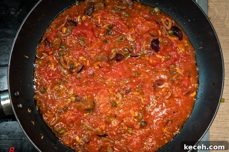Vegan Puttanesca Sauce Recipe Without Anchovies 8 Adding the tomatoes to the pan