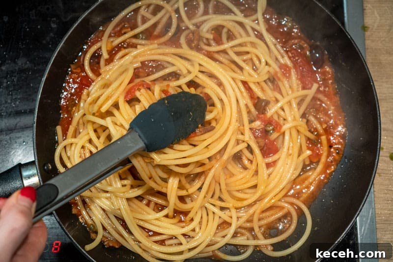 Vegan Puttanesca Sauce Recipe Without Anchovies 9 Tossing the pasta in the sauce