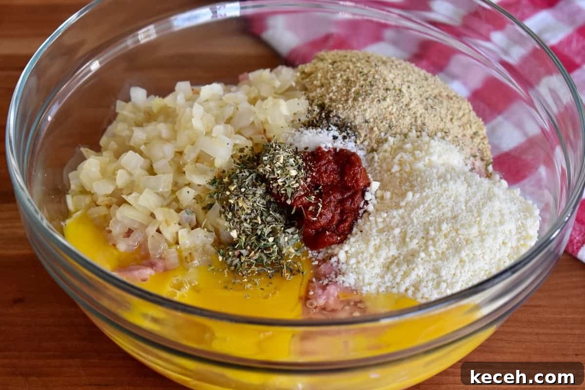 Italian-Style Turkey Meatloaf with Herbs and Parmesan 5 Ingredients for recipe in a glass bowl.