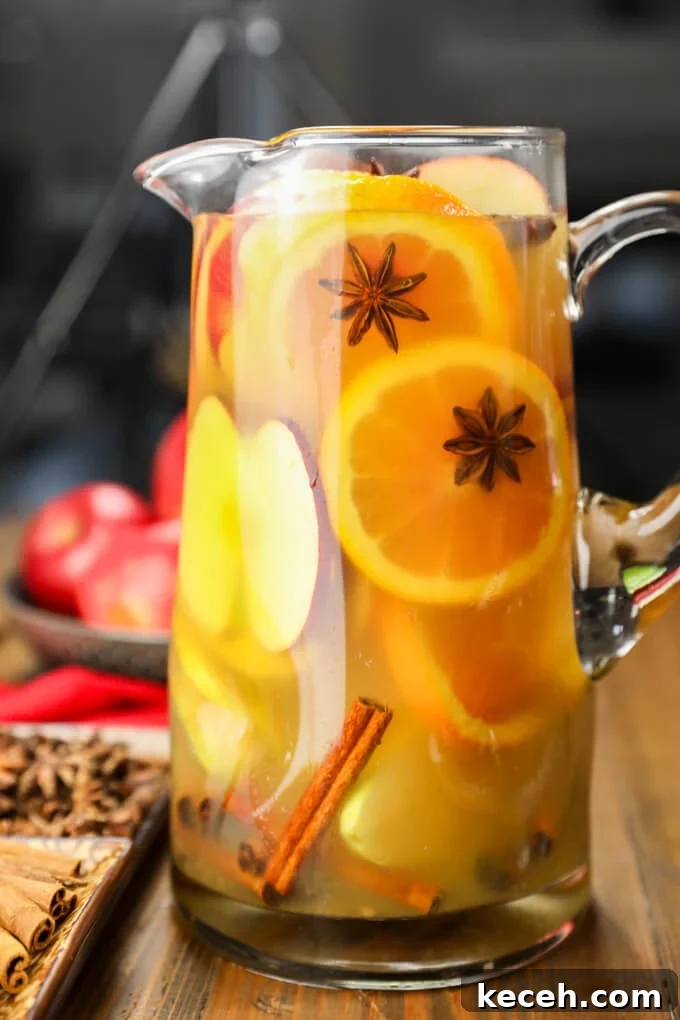 Autumn Apple Cider Sangria with Bourbon Twist 5 A pitcher of apple cider sangria with slices of oranges, apples and pears. There are also cinnamon sticks and star anise in the sangria.