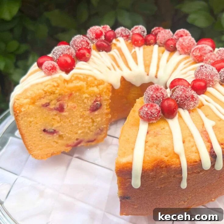 Cranberry Orange Pound Cake, sliced, on a cake plate.