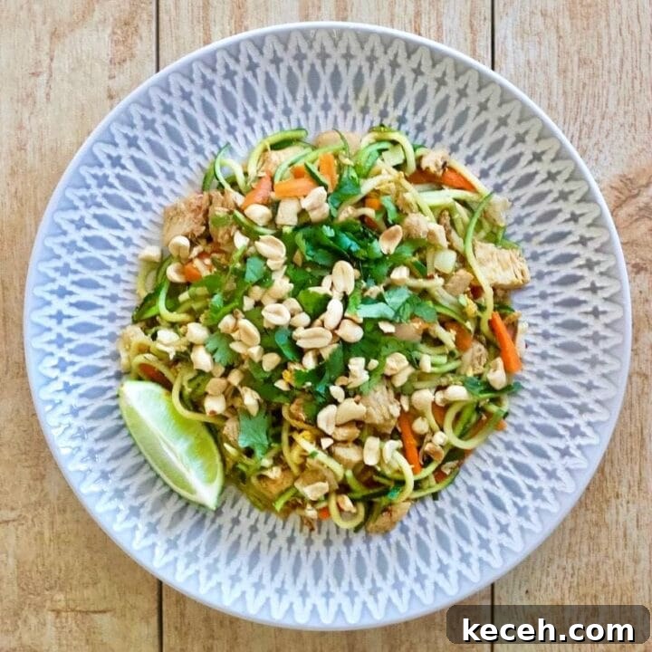 Plate of Zucchini Noodles with chicken, peanuts, carrots and pad Thai sauce