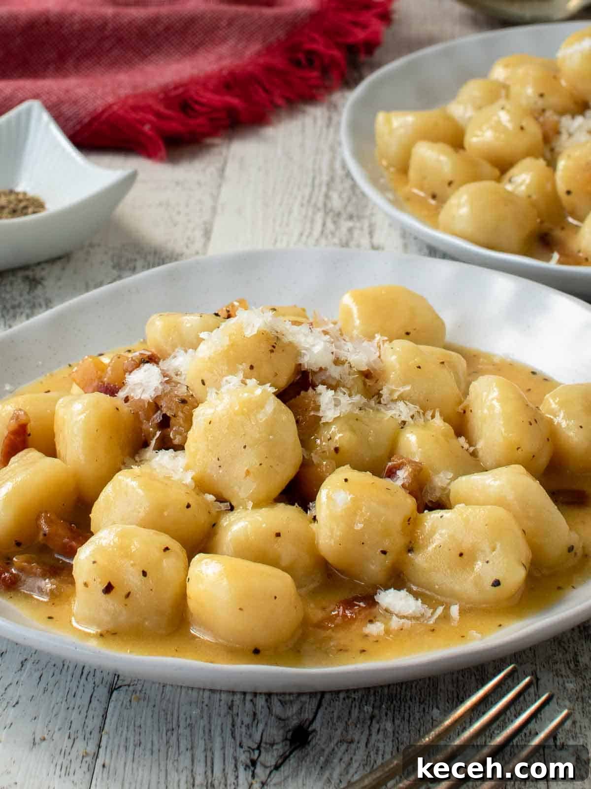 Gnocchi carbonara on a white plate.