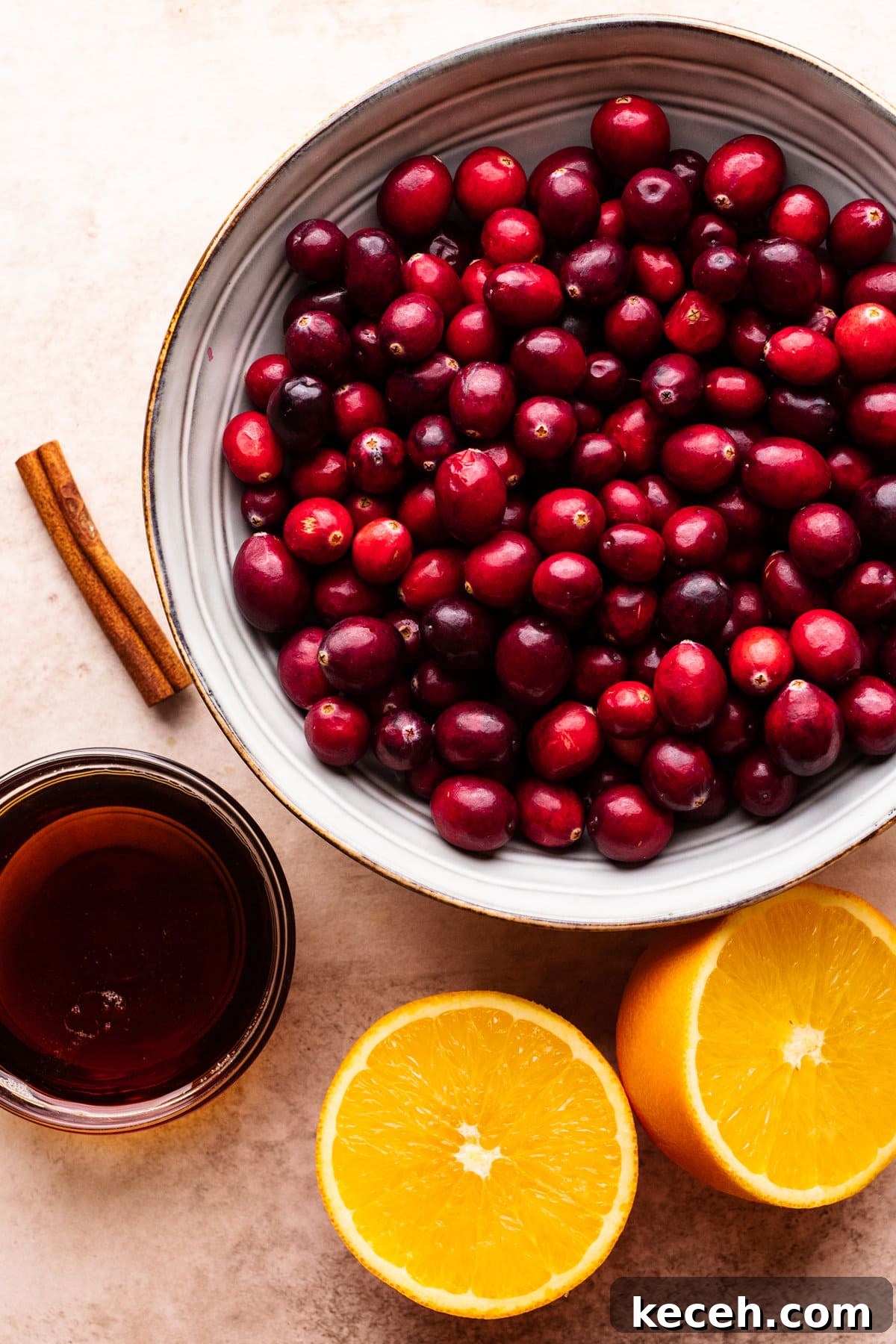Cranberry Orange Sauce Recipe for Holiday Tables 3 Ingredients for cranberry orange sauce arranged on a tan background.