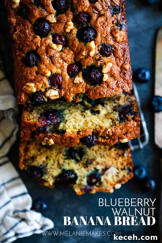 An overhead view of a slice of Blueberry Walnut Banana Bread with two slices cut.