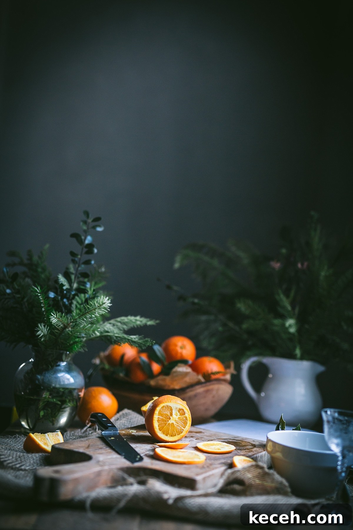 Vasilopita (Greek New Year Cake) — Slow Cooker or Oven Recipe 4 A still life of an orange being sliced for Vasilopita.