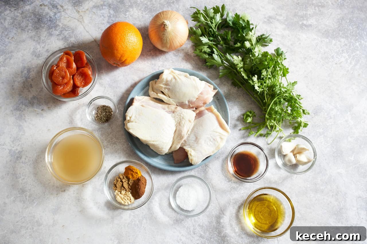 Skillet Chicken Tagine with Apricots and Warm Spices 3 An onion, an orange, bunches of fresh parsley and cilantro, small bowls of spices, vinegar, olive oil, garlic, and chicken stock.