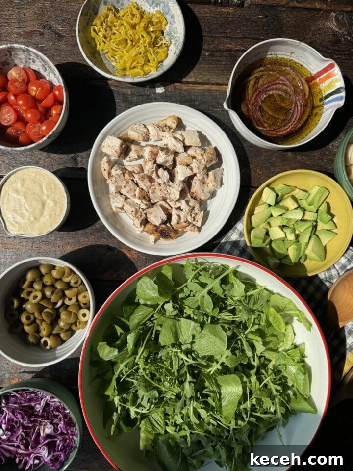 Vibrant fresh salad ingredients including greens, tomatoes, chicken, and toppings for healthy eating.