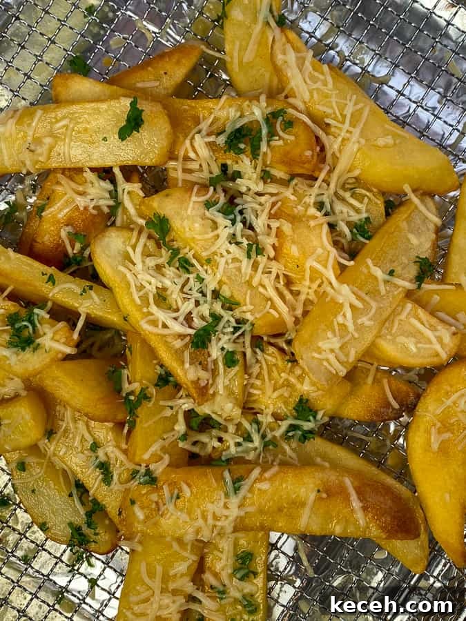 Steak fries bathed in garlic butter and loaded with shredded Parmesan cheese