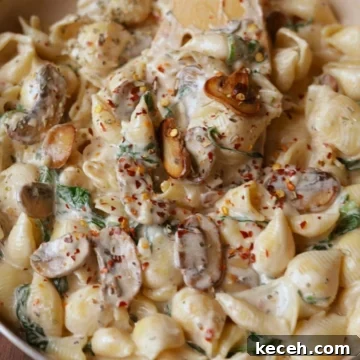 Creamy Mushroom & Spinach Pasta Recipe for Weeknight Dinners 6 Creamy mushroom and spinach pasta in a off white pan.