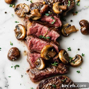 Cooked rib eye steak with mushrooms.
