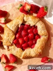 galette with gooey strawberry filling and surrounded by fresh strawberries