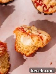 rhubarb muffins with cream cheese filling, rhubarb topping, and crumble