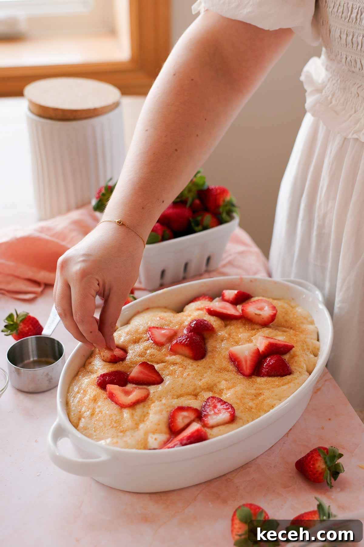 Cream Cheese Strawberry Cobbler Recipe — Sweet Rustic Dessert 10 laying strawberries over strawberry cobbler