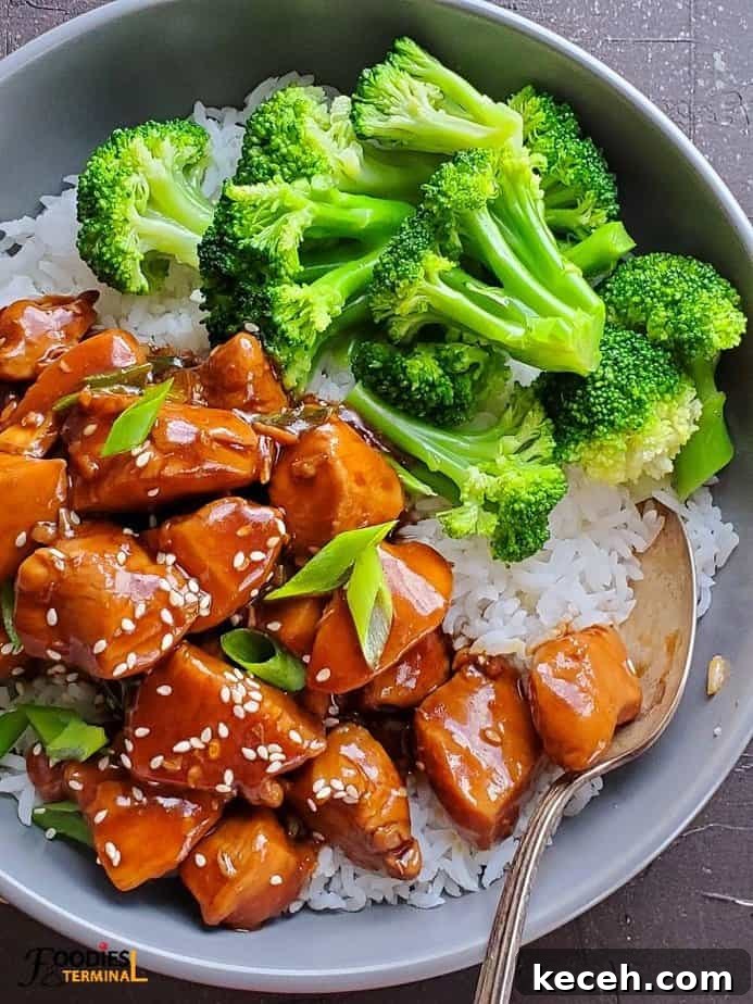 Instant Pot Teriyaki Chicken Recipe: Tender, Savory & Fast 2 Instant Pot chicken teriyaki served in a grey bowl over rice with steamed broccoli florets on the side