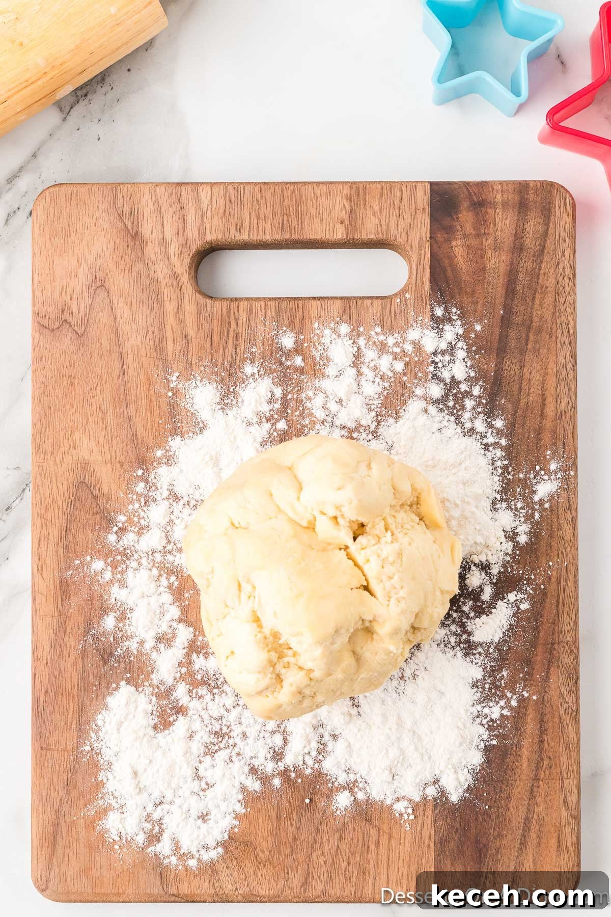 Dough on cutting board with flour. 