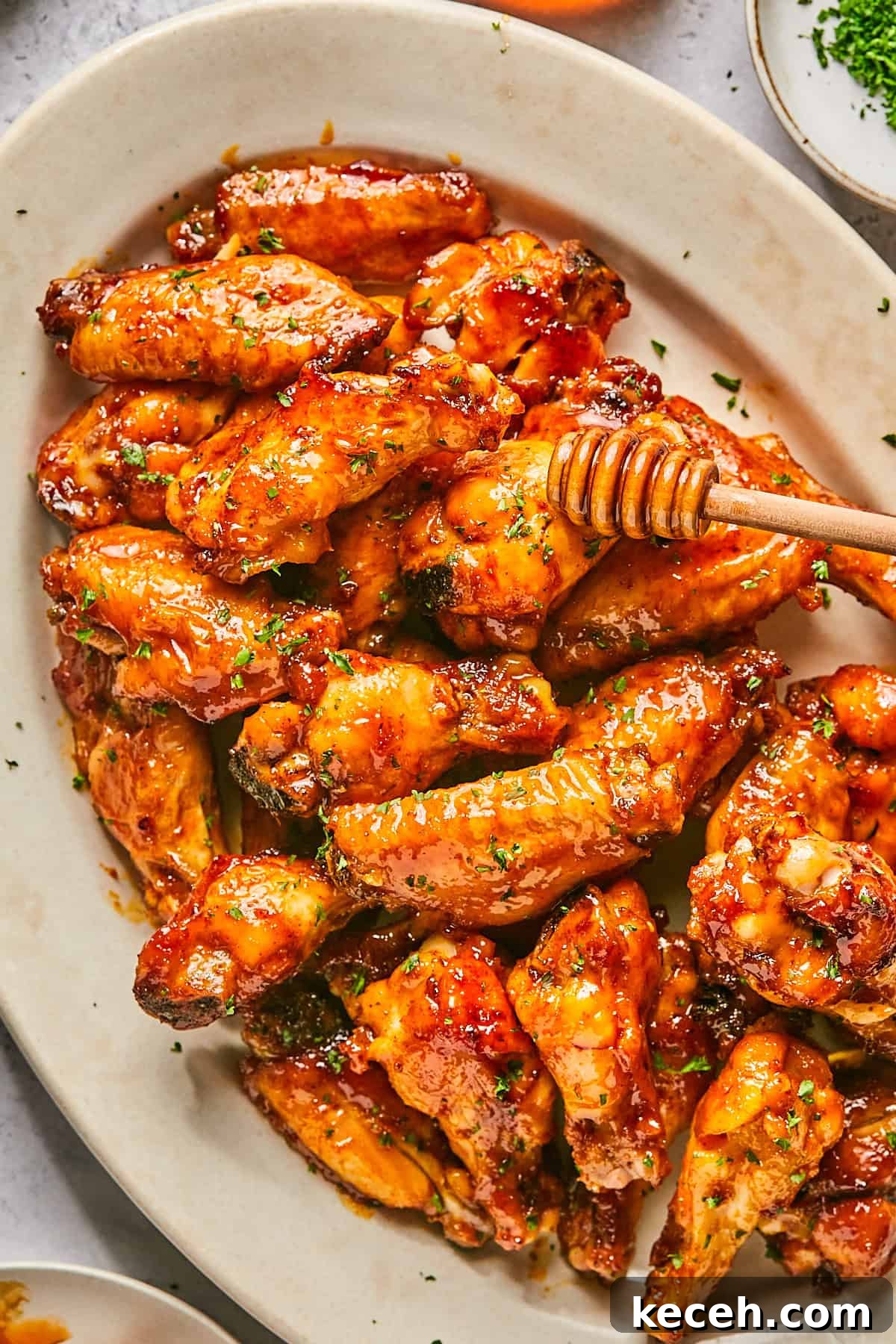 chicken wings with honey being drizzled on top