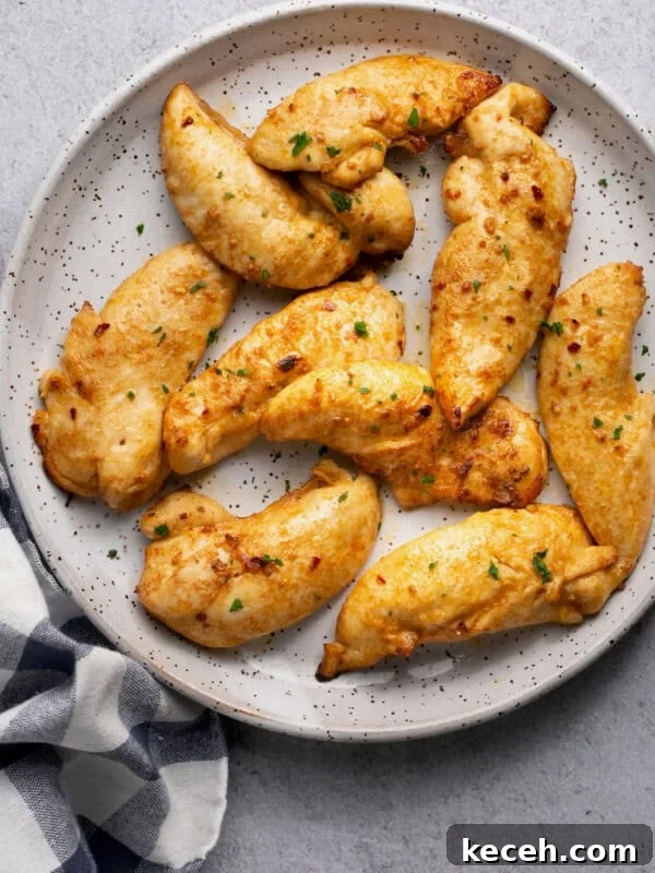 air fryer chicken tenderloins on a plate with a black and white checkered napkin underneath