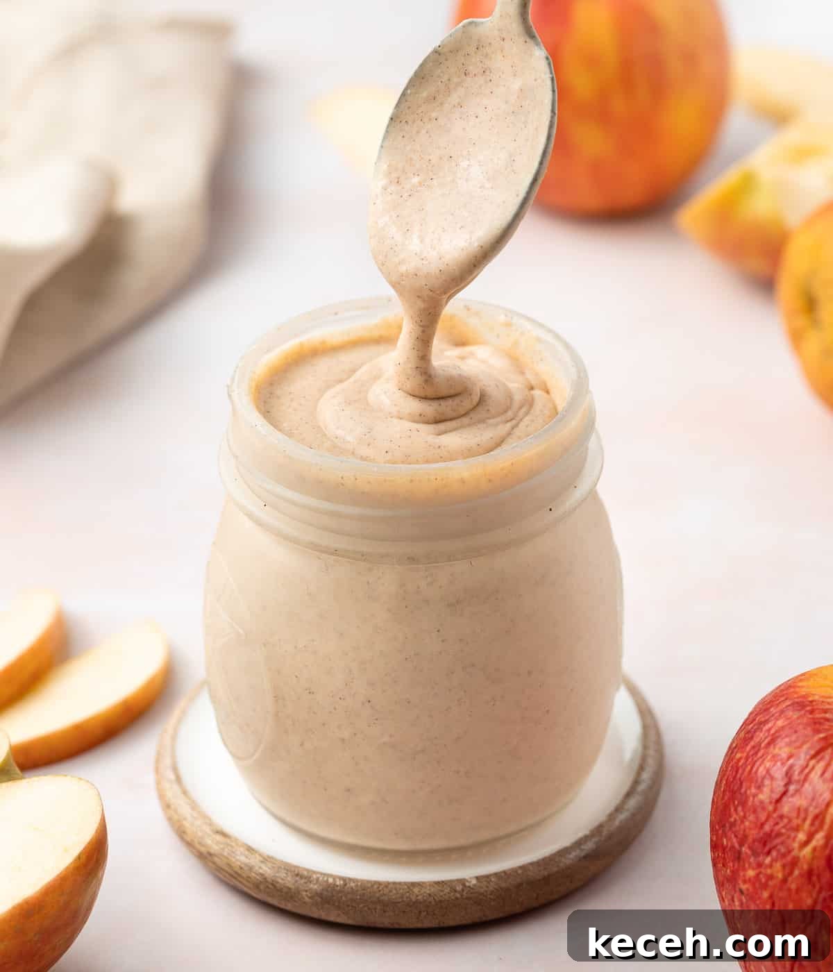 Apple Curd Recipe: Smooth Homemade Apple Spread 7 Pouring some curd from a spoon into the jar.