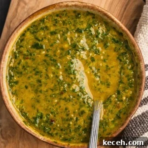 A bowl of North African Chermoula sauce on a wooden board.
