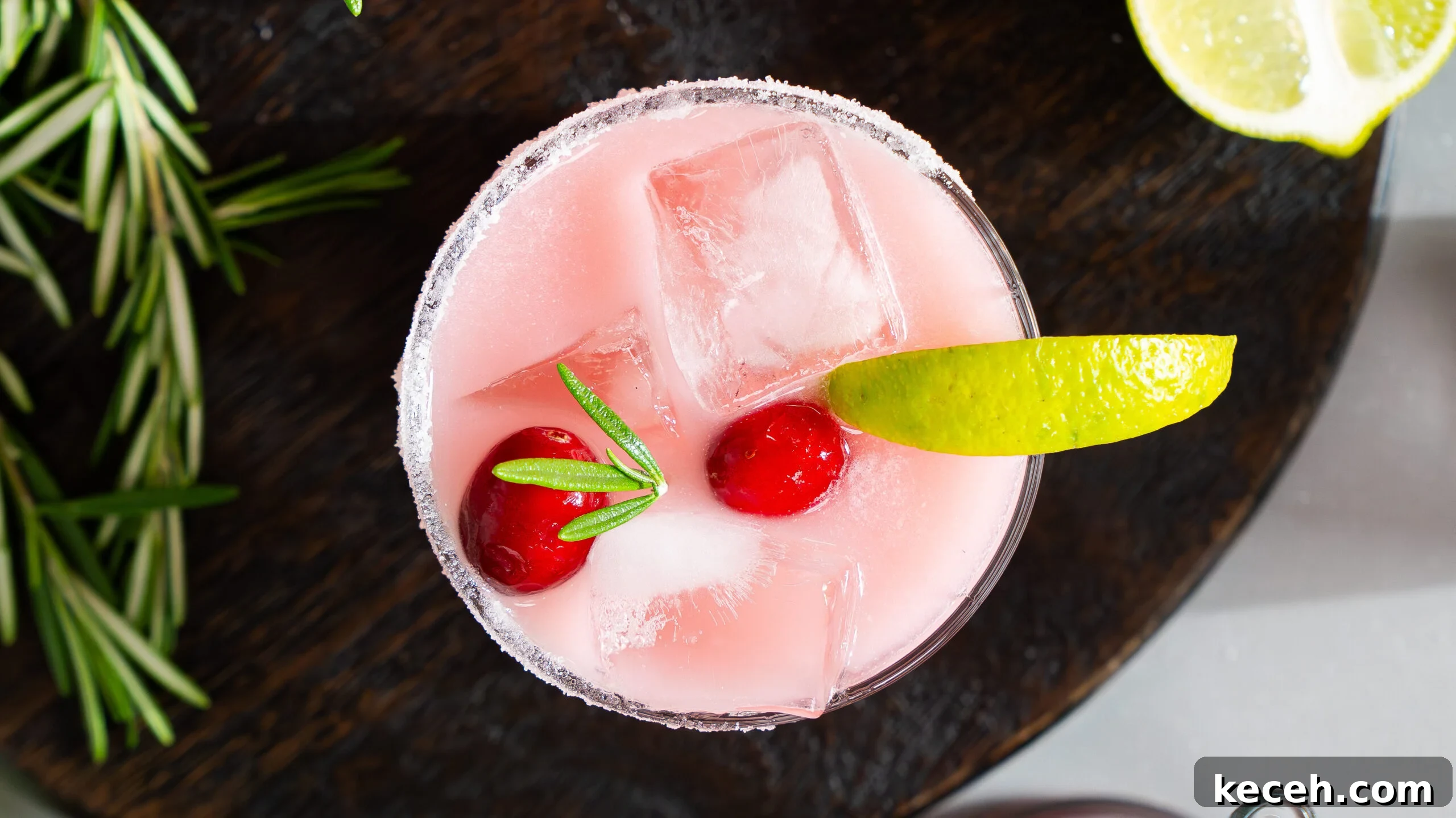 Cranberry Coconut Lime Christmas Margarita Recipe 3 Christmas margarita in a glass with lime and cherries,