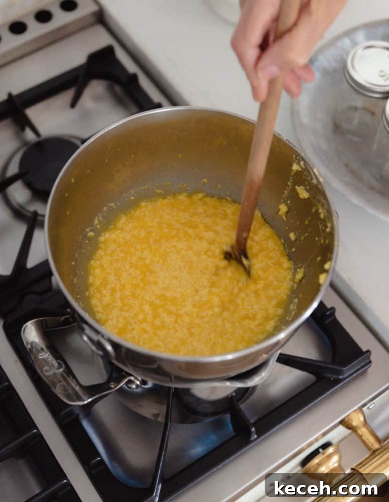 No-Fail Orange Curd Recipe — Smooth, Tangy, Homemade 6 Double boiler on stove making orange curd.