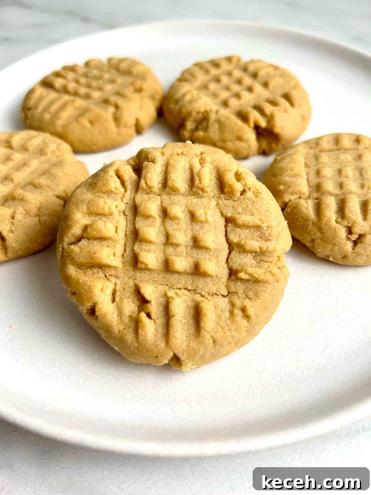 Chewy Peanut Butter Cookies Recipe with Crispy Edges 2 close up of peanut butter cookies on plate.