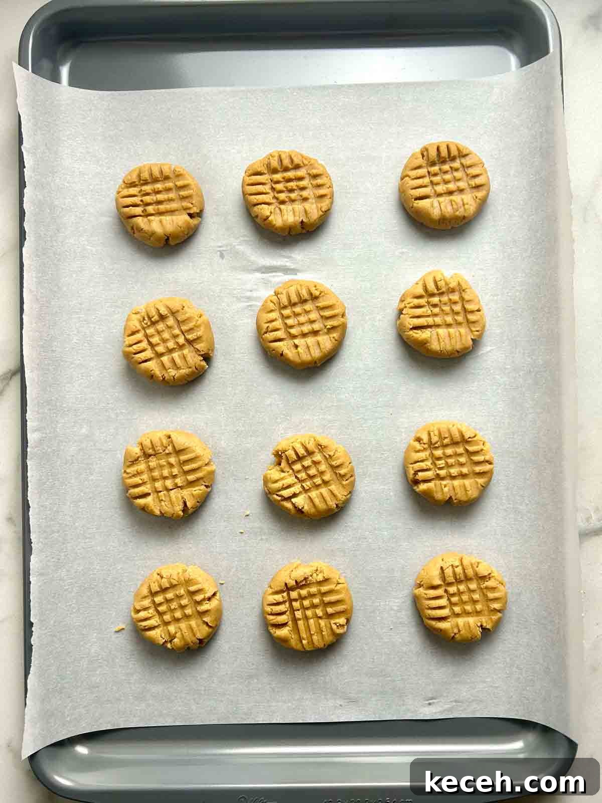 Chewy Peanut Butter Cookies Recipe with Crispy Edges 7 cookie dough balls flattened with fork.