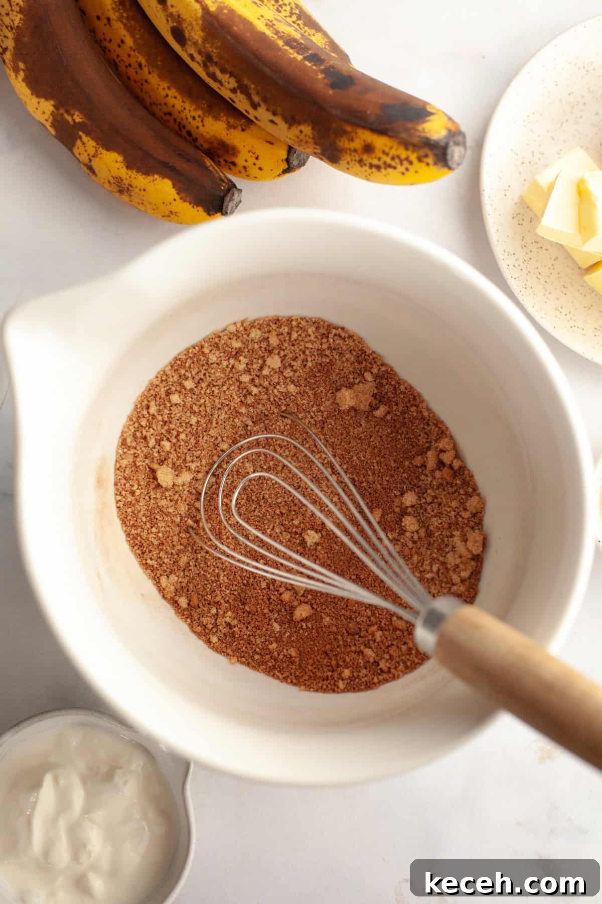 Moist Banana Coffee Cake with Sour Cream Glaze 4 A large white bowl with cinnamon and brown sugar in it.