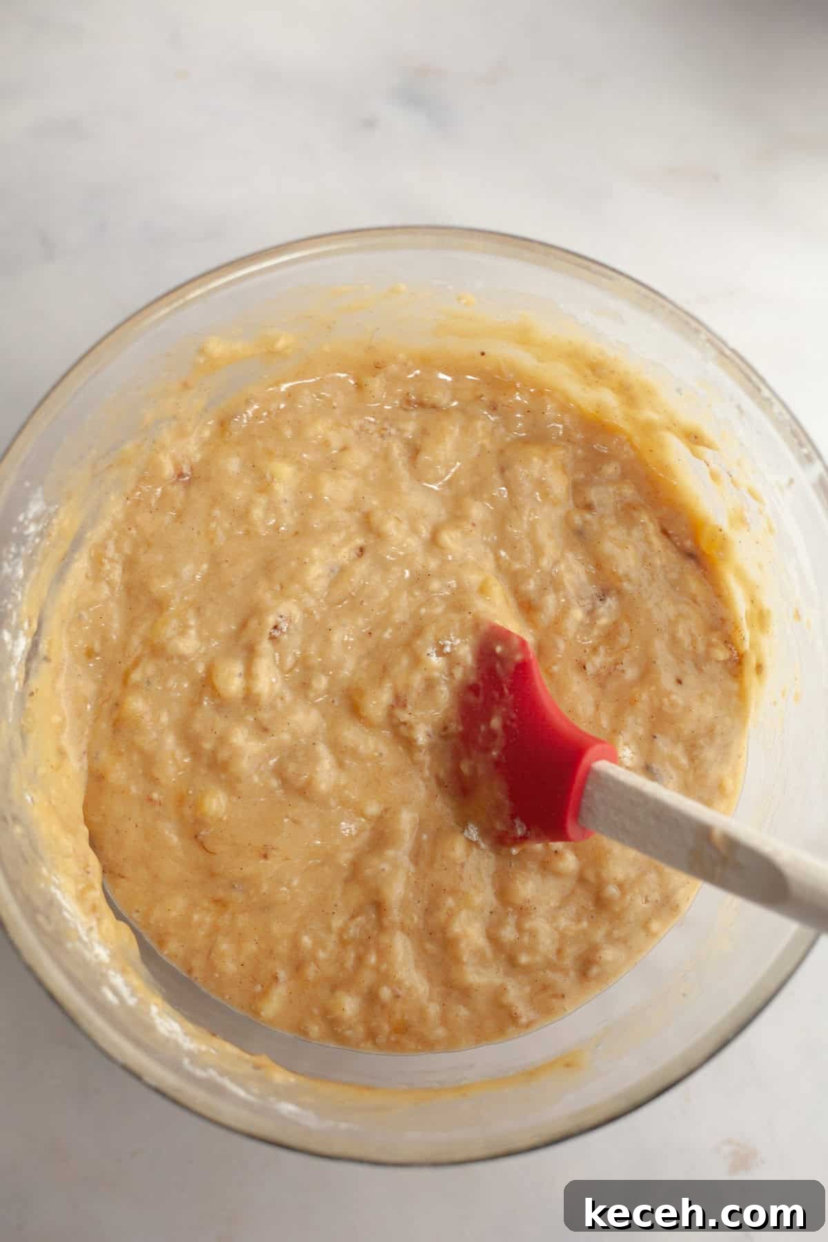 Moist Banana Coffee Cake with Sour Cream Glaze 8 A large glass bowl with a rubber spatula and banana bread batter.