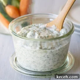 Creamy Green Goddess Dressing & Herb Dip Recipe 8 Green goddess dip and dressing in a jar with a wooden spoon for serving.