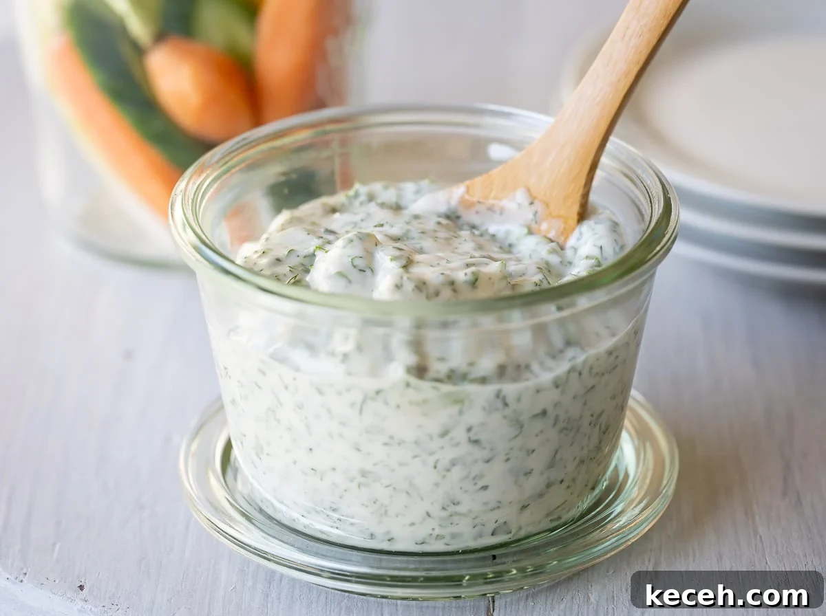 Creamy Green Goddess Dressing & Herb Dip Recipe 7 Green Goddess Dressing and Dip in a jar surrounded by raw veggies as a dip platter.