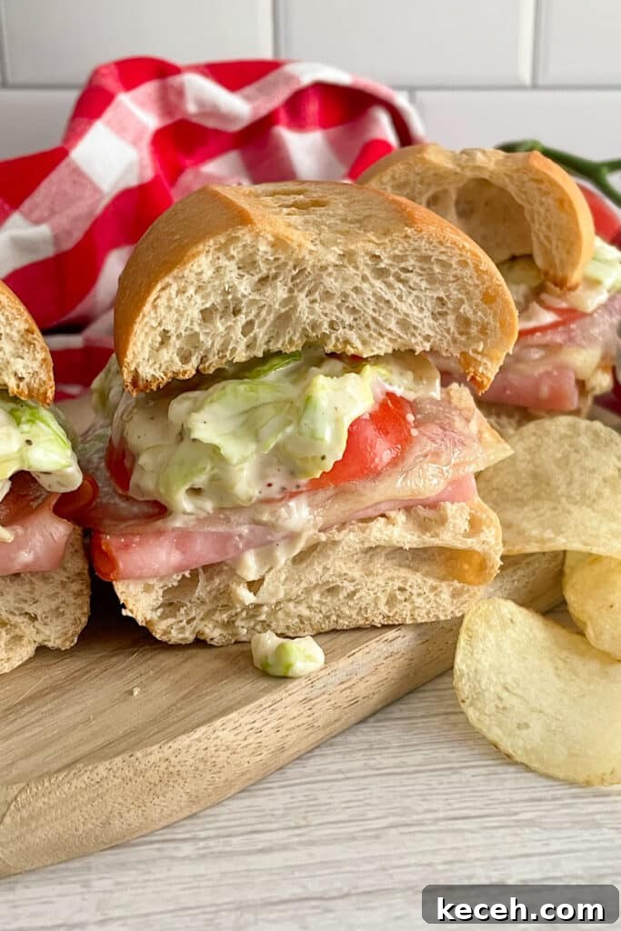 Italian Deli-Style Grinder Sandwich Recipe (Copycat) 2 Copycat Grinders Italian sandwich cut in half for serving.