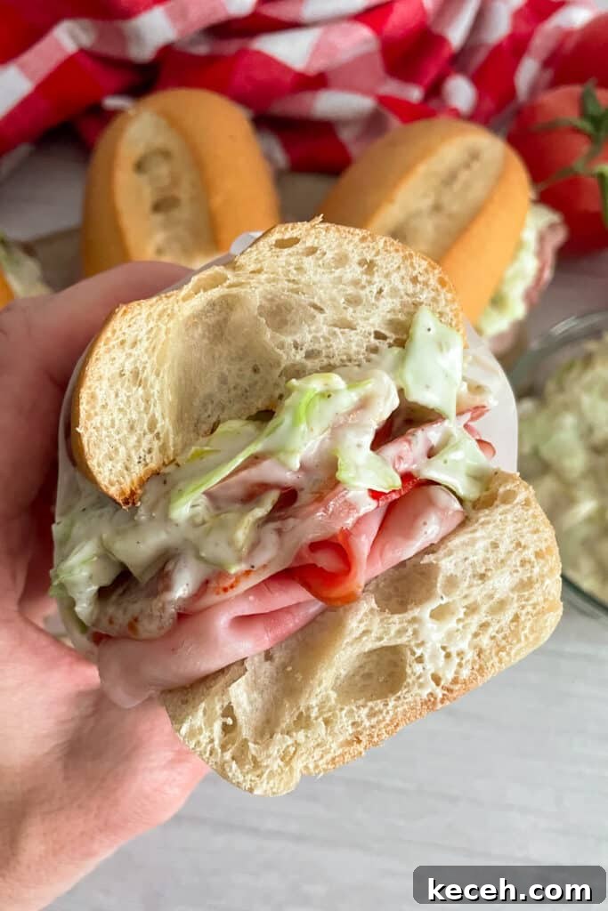 Italian Deli-Style Grinder Sandwich Recipe (Copycat) 3 close up shot of Grinders Italian sandwich cut in half showing the inside