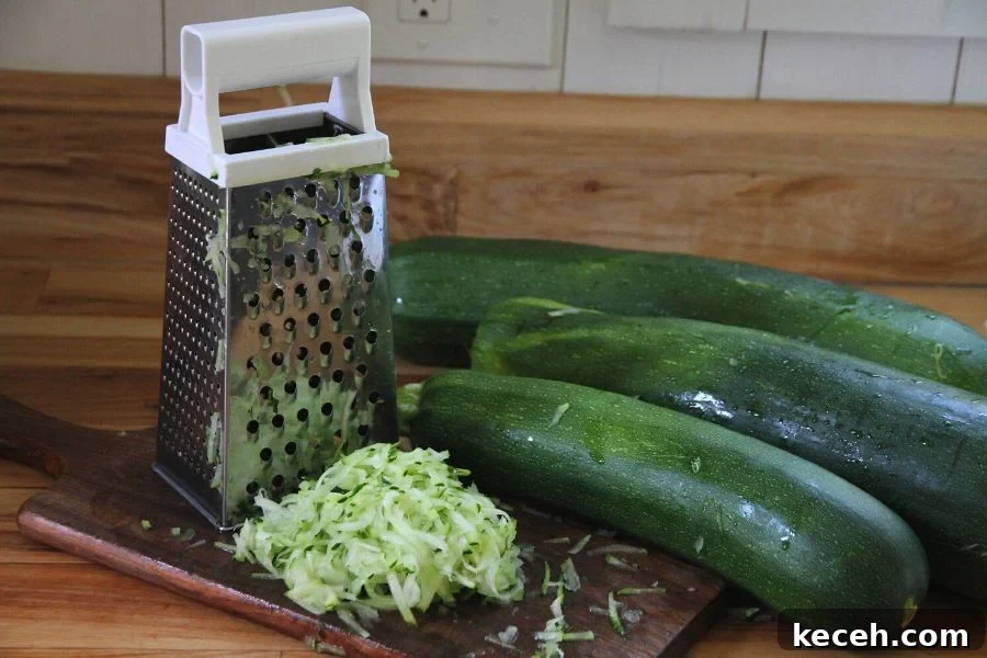 Freeze Fresh Zucchini from the Garden: Step-by-Step Guide for Crispy Texture 2 a cutting board, grater and a pile of freshly grated zucchini