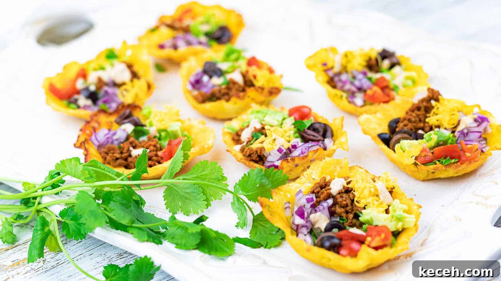 13 Delicious Low-Carb Mexican Recipes Worth Trying 7 Easy Crunchy Keto Taco Cups on a white board with cilantro.