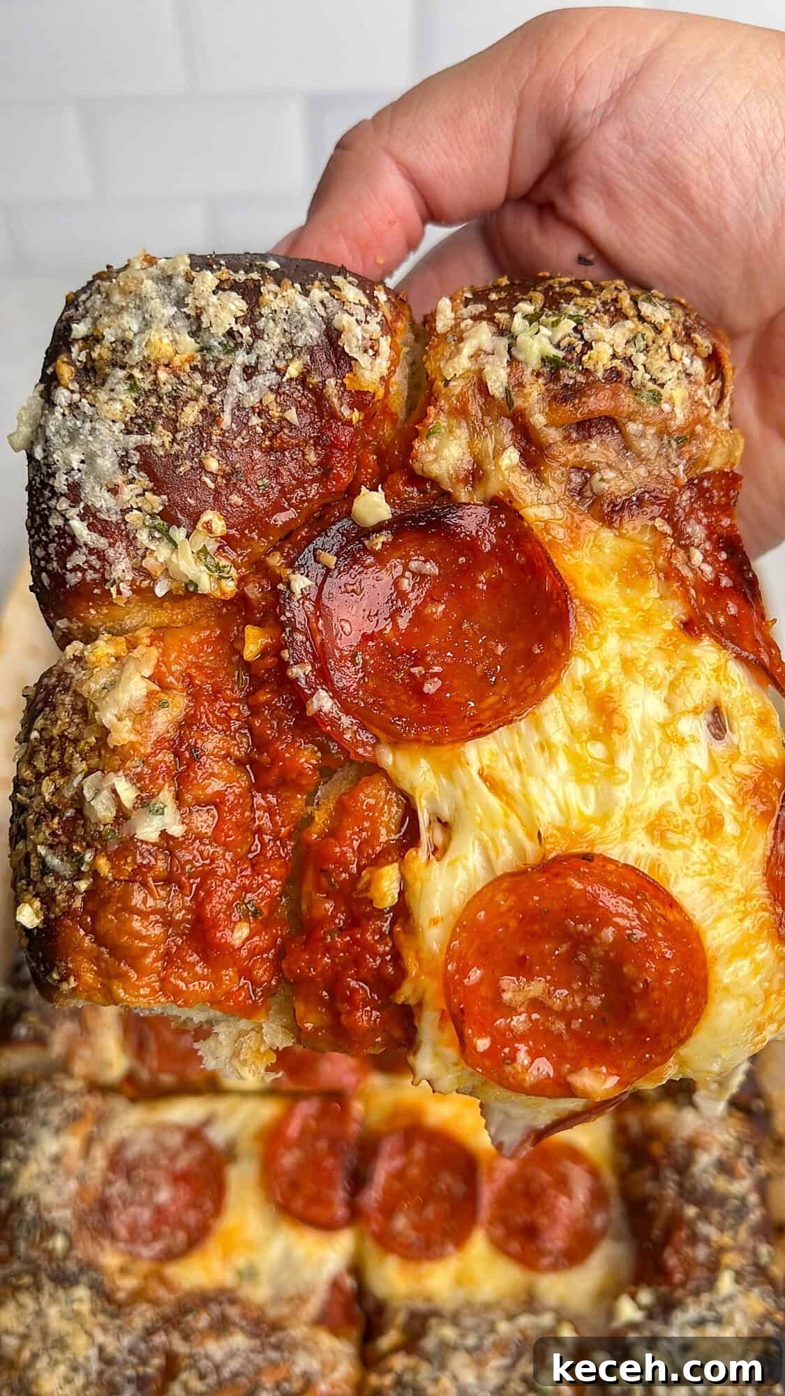 square slice of pizza on hawaiian rolls