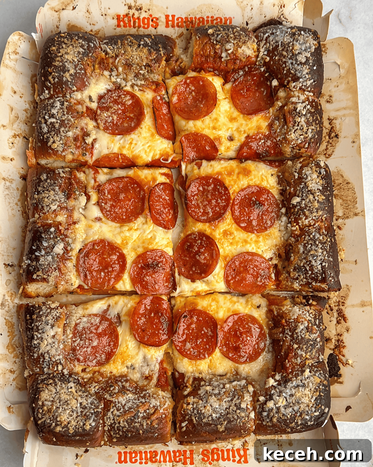 a sliced pepperoni pizza using hawaiian rolls as the crust