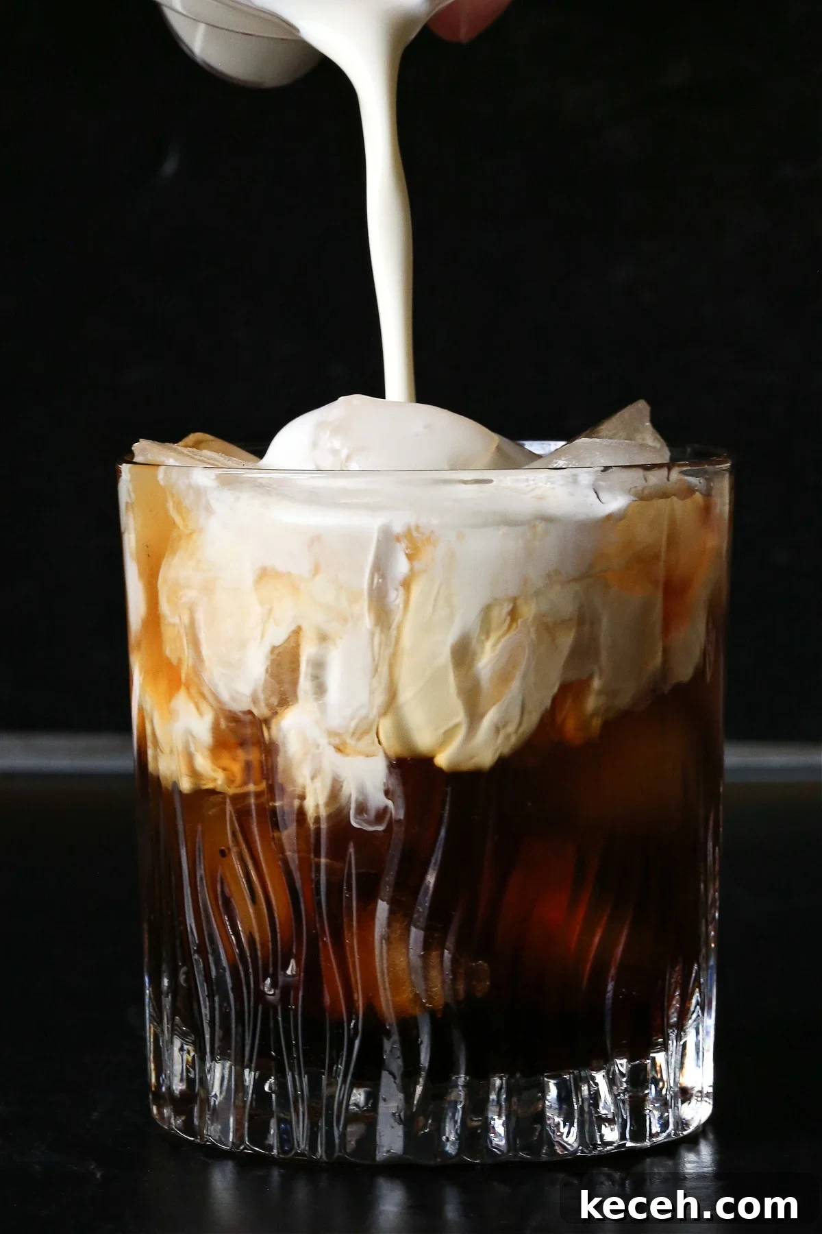 A classic White Russian recipe is a favorite with coffee lovers. A creamy, coffee-infused cocktail that's wonderful as an after dinner drink. cream being poured into white russian drink