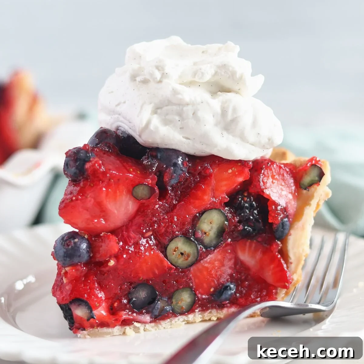 Gluten-Free Mixed Berry Pie Recipe — Fresh Summer Dessert 2 large slice of berry pie with whipped cream on top on white plate.