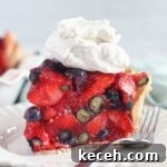 Gluten-Free Mixed Berry Pie Recipe — Fresh Summer Dessert 12 large slice of berry pie with whipped cream on top on white plate.