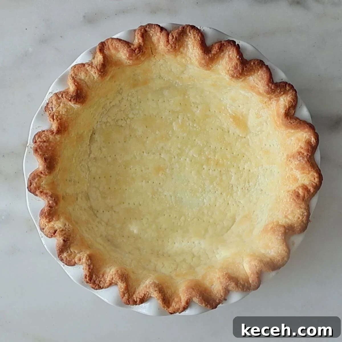 Gluten-Free Mixed Berry Pie Recipe — Fresh Summer Dessert 4 fully baked pie shell on marble surface.