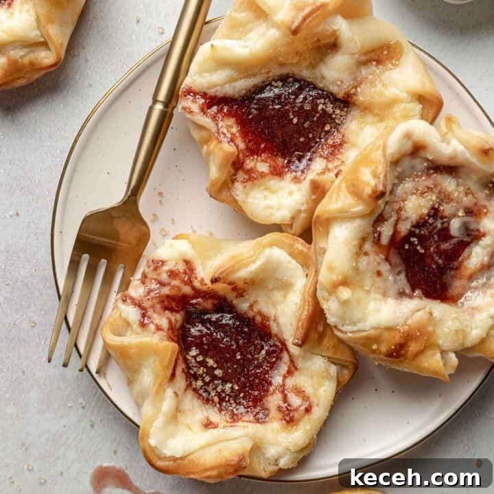Three Starbucks copycat sugar plum danish on a small plate next to a fork and coarse sugar.