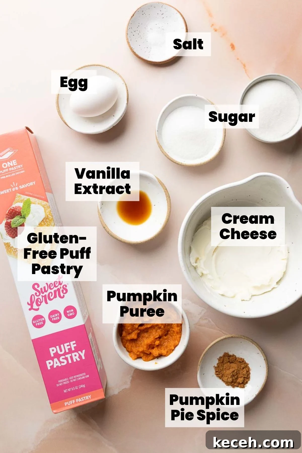 Gluten-Free Pumpkin Cream Cheese Danish Recipe — Starbucks Copycat 3 Ingredients for gluten-free pumpkin danish laid out on a light surface, each labeled. Includes gluten-free puff pastry, egg, salt, sugar, vanilla extract, cream cheese, pumpkin puree, and pumpkin pie spice.