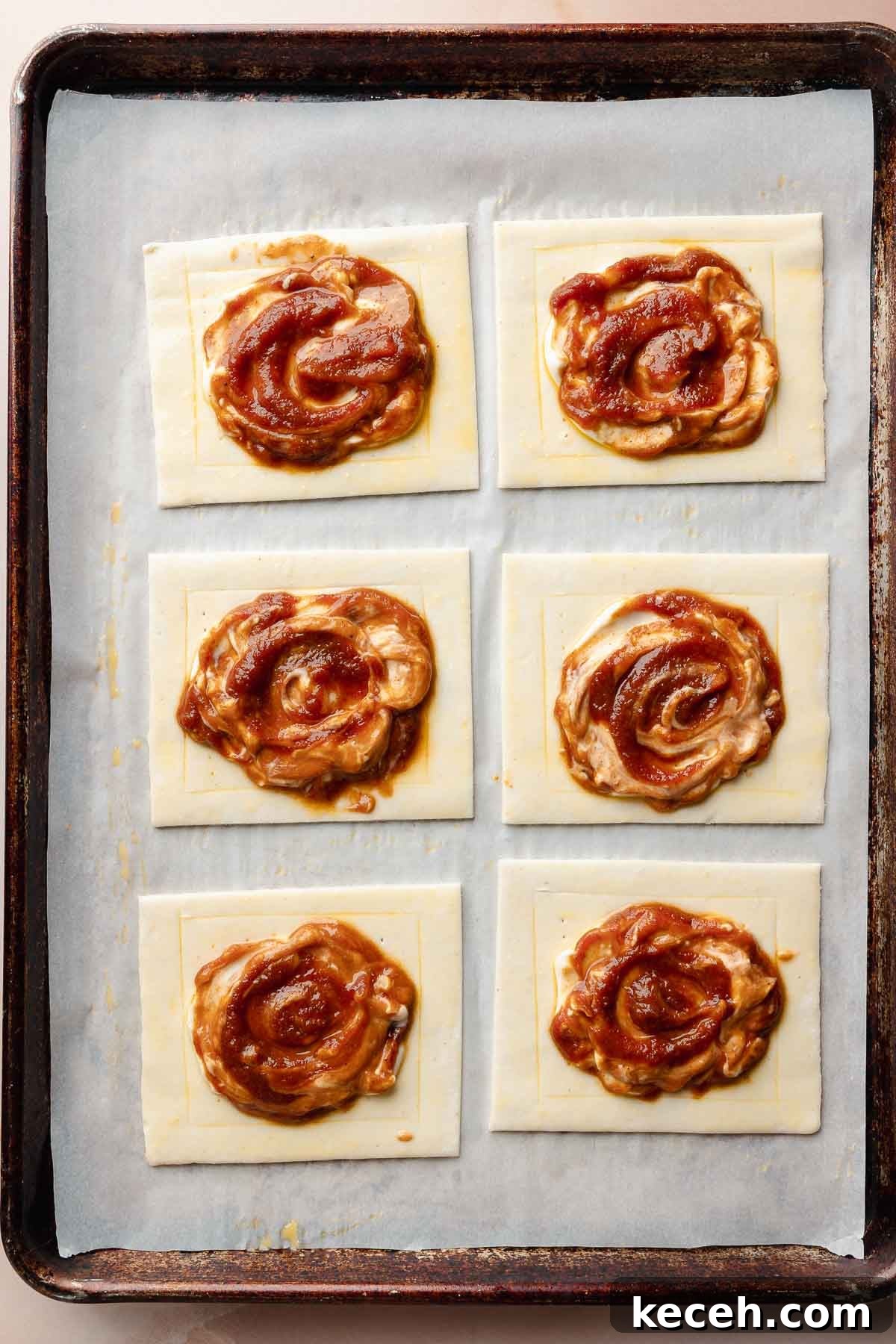 Gluten-Free Pumpkin Cream Cheese Danish Recipe — Starbucks Copycat 7 All pastries are filled and ready for baking. The pumpkin and cream cheese filling is swirled in the center of each pastry square.