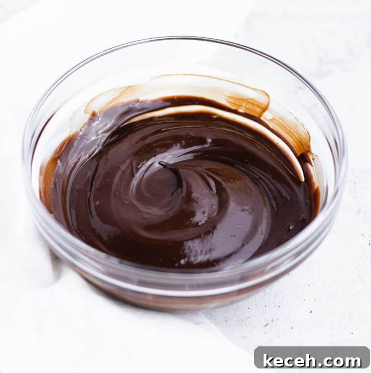 Chocolate Ganache Recipe: Smooth, Glossy Ganache in Minutes 8 Chocolate ganache in a clear bowl cooled so that it holds a swirl.